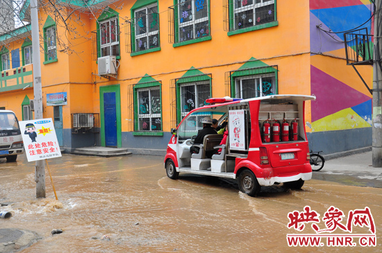 巡防隊員將巡消車開到對面，將上學的小朋友一個一個接上車，送出家屬院