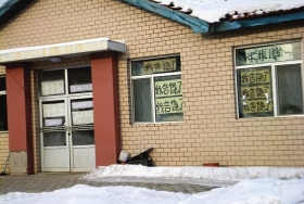 伊春市帶嶺區(qū)一排破舊的平房，房間窗戶上貼滿了“我告饒了”的字樣。