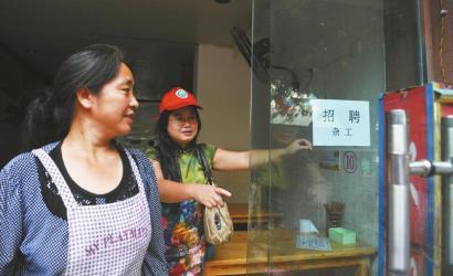 8月14日，市民志愿者體驗城管執(zhí)法招呼商家不要亂張貼。