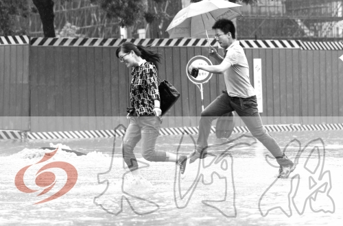 鄭州經(jīng)三路與北環(huán)交叉口處，積水較深，行人們不得不“練輕功”。 記者 白周峰 攝影