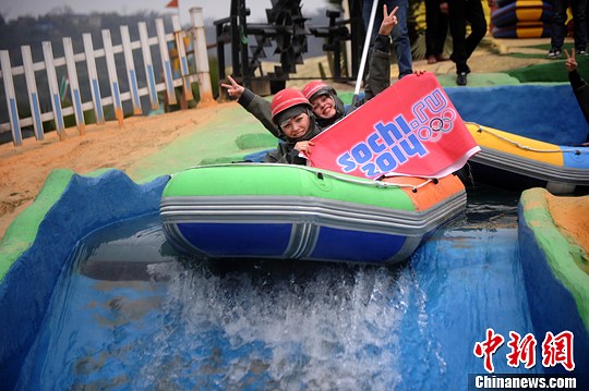 　圖為外國友人舉著標(biāo)語體驗(yàn)水上漂。陳超　攝