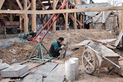 東城區(qū)北鑼鼓巷與小經(jīng)廠胡同之間一處四合院內(nèi)，工人進(jìn)入已經(jīng)挖好的地下室內(nèi)施工。