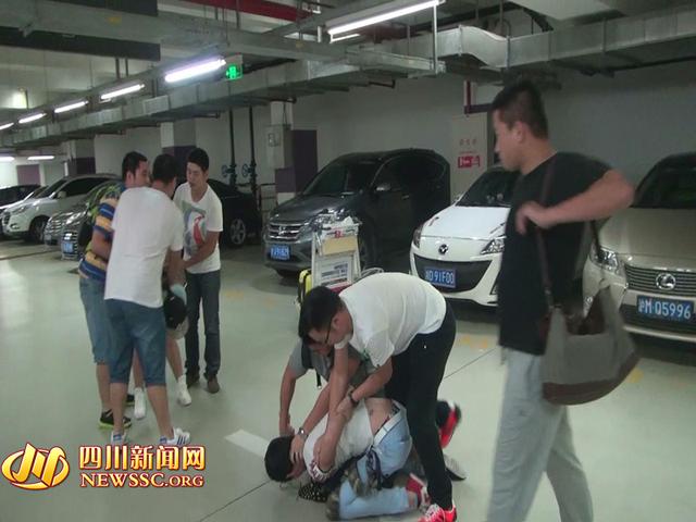 辦案人員在機(jī)場(chǎng)停車場(chǎng)抓獲胡某及其女友（警方視頻截圖）。