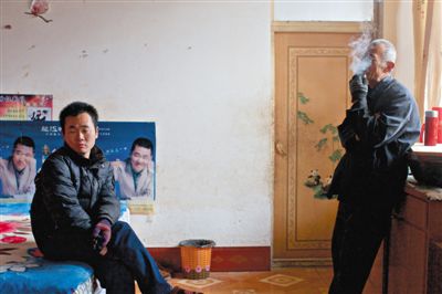 父親抽煙，兒子不語(yǔ)。逃跑的越南新娘，給袁迎賓父子帶來(lái)的是失落。新京報(bào)記者 周崗峰 攝
